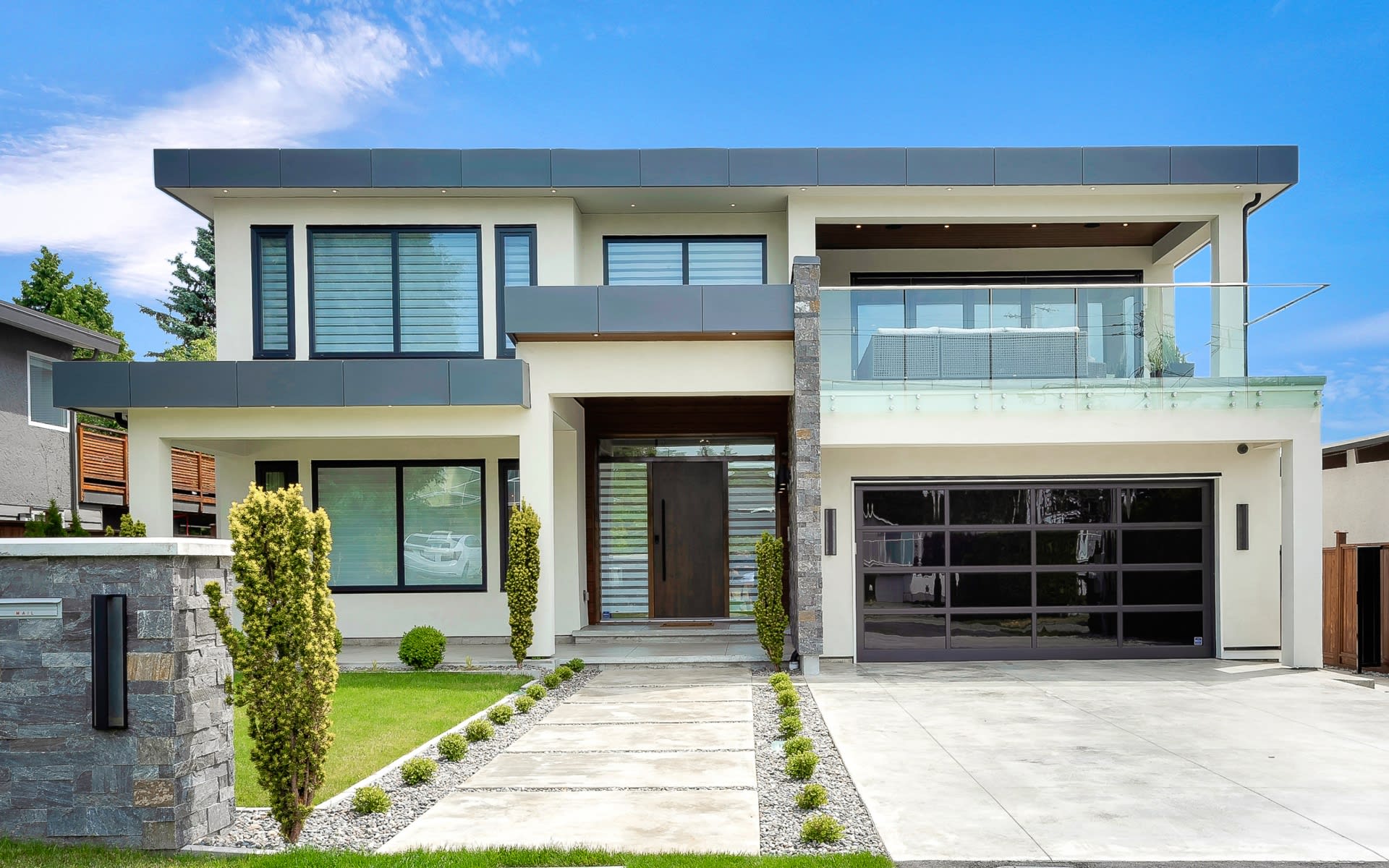 Modern house with garage door and balcony