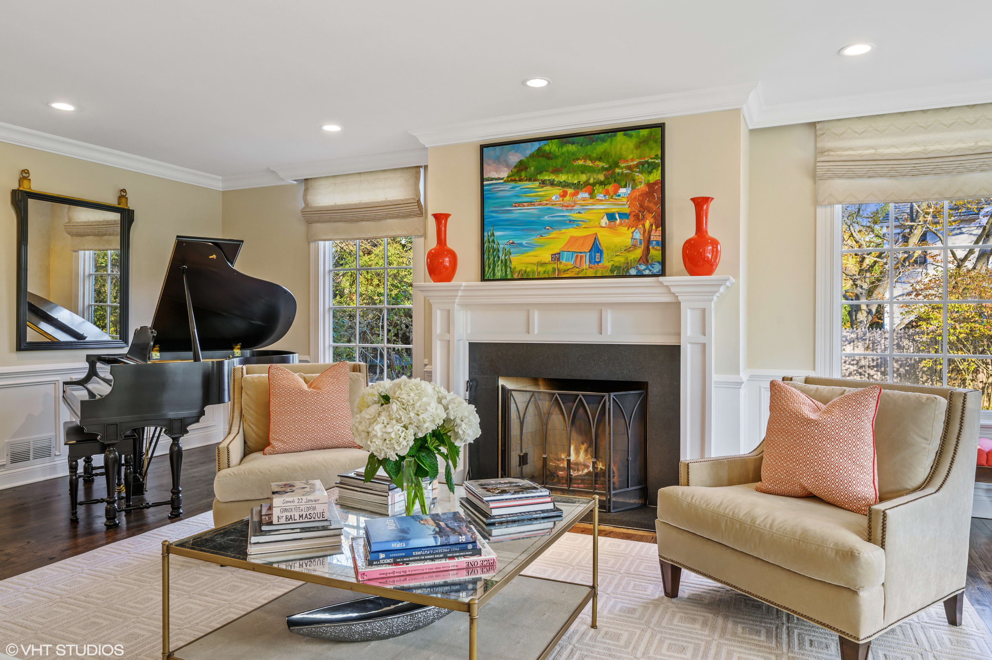 A living room with a grand piano and a fireplace