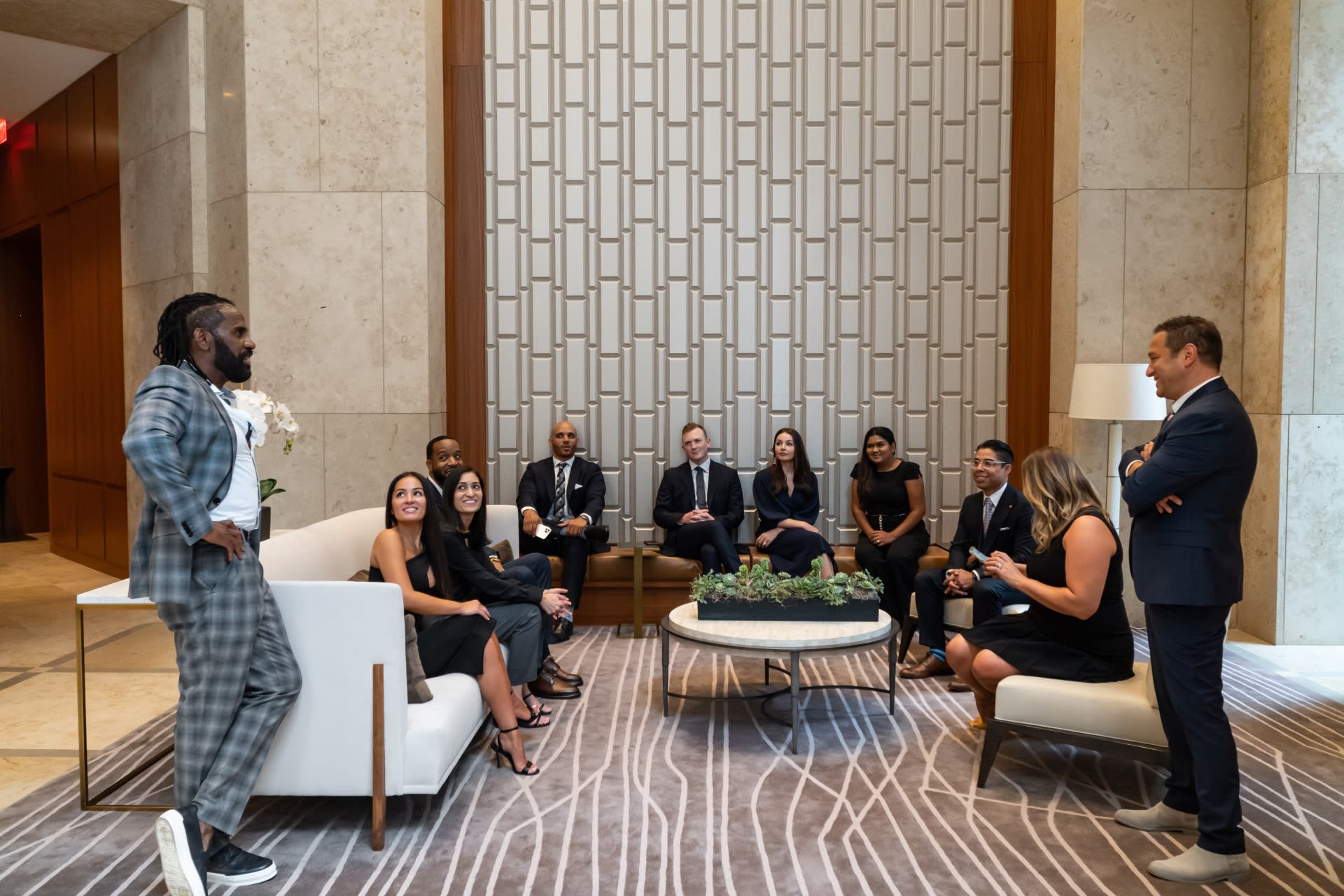 Team Francesco seated in a lobby and engaged in conversation.