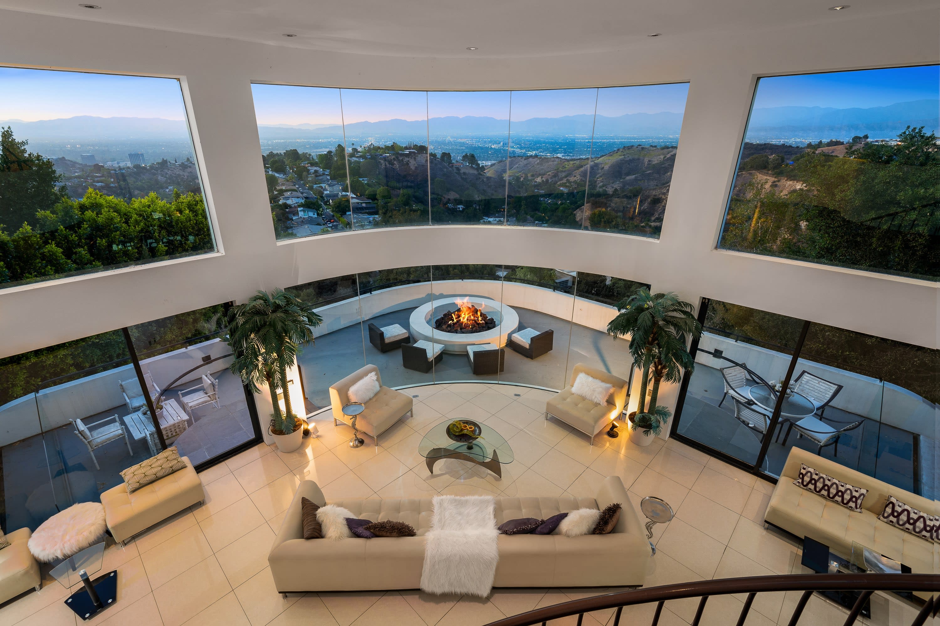 A living room with a fireplace and a view of the mountains