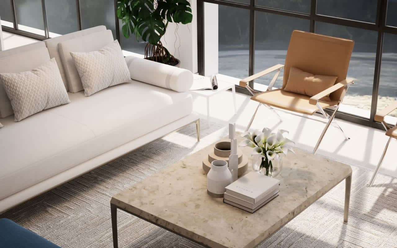 A living room with a couch, chair, coffee table, and vase of flowers