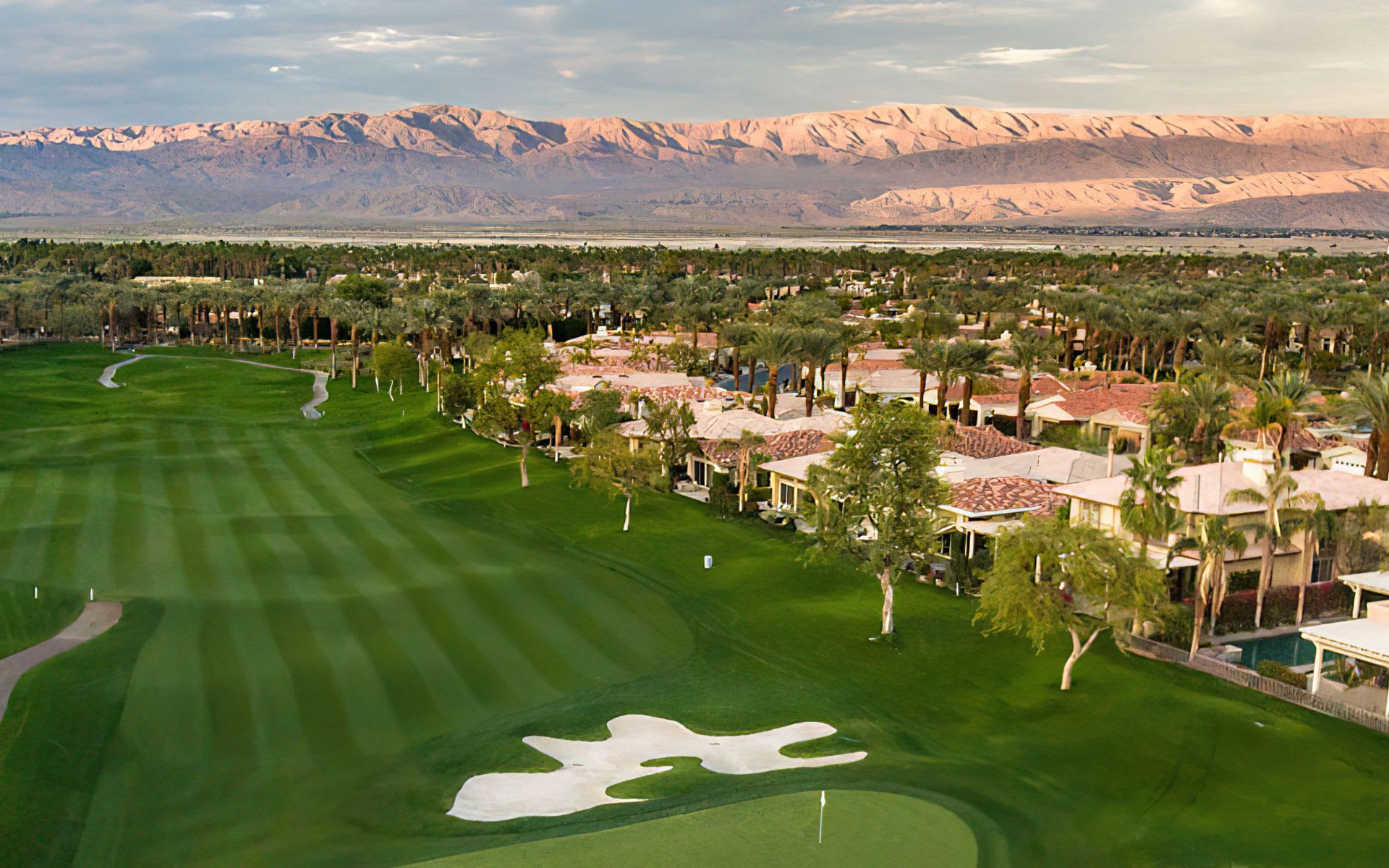 An aerial view of a golf course with manicured greens