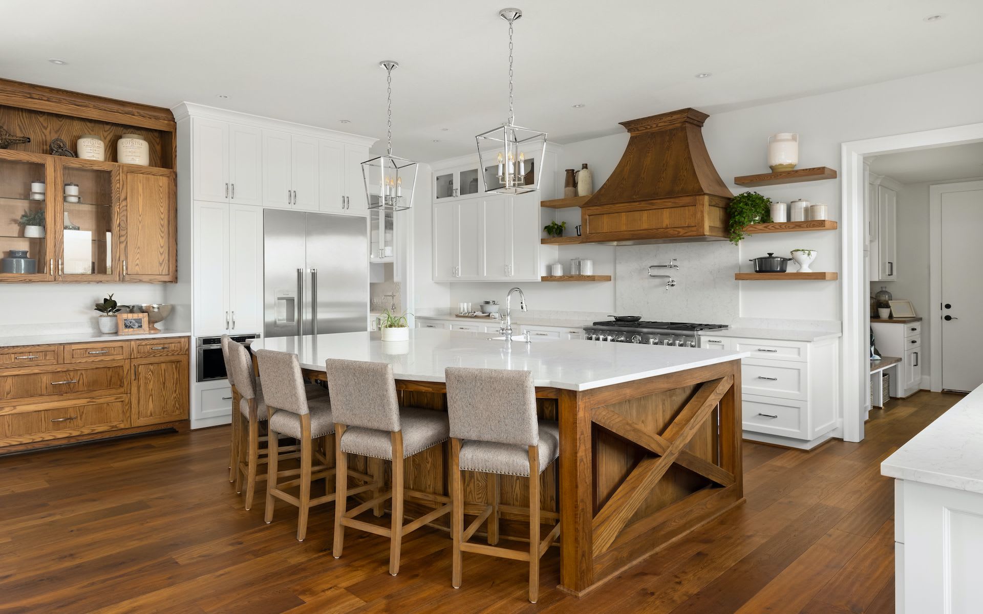 A modern kitchen with a large center island made of wood with white counter top