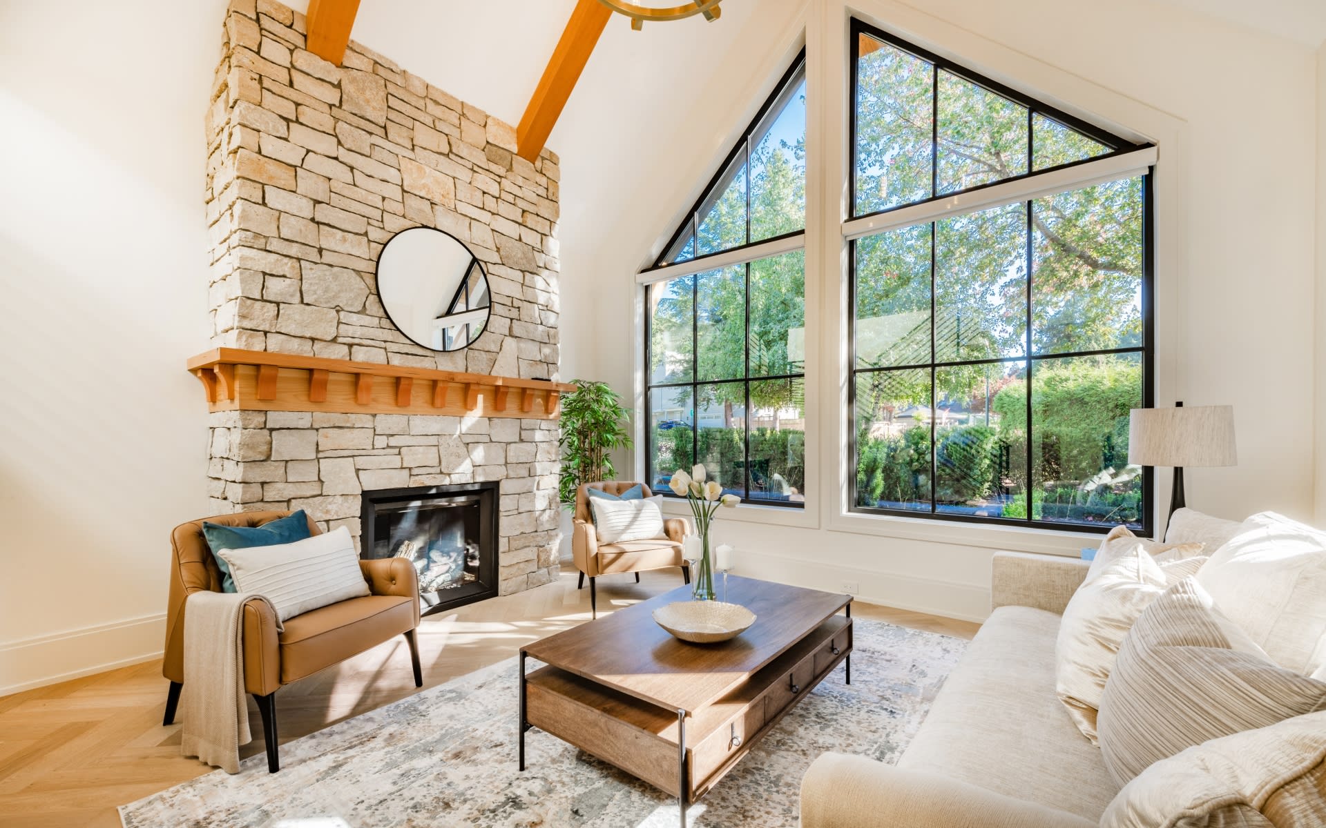 Elegant living room with stone fireplace and floor-to-ceiling windows
