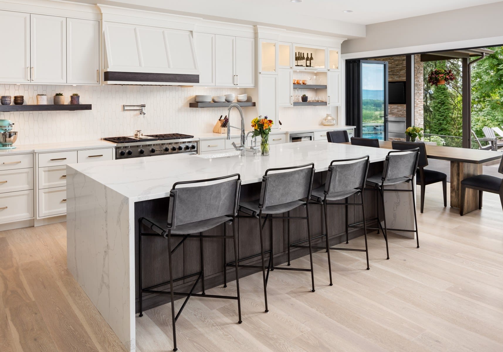 A spacious kitchen with a large central island made of white marble