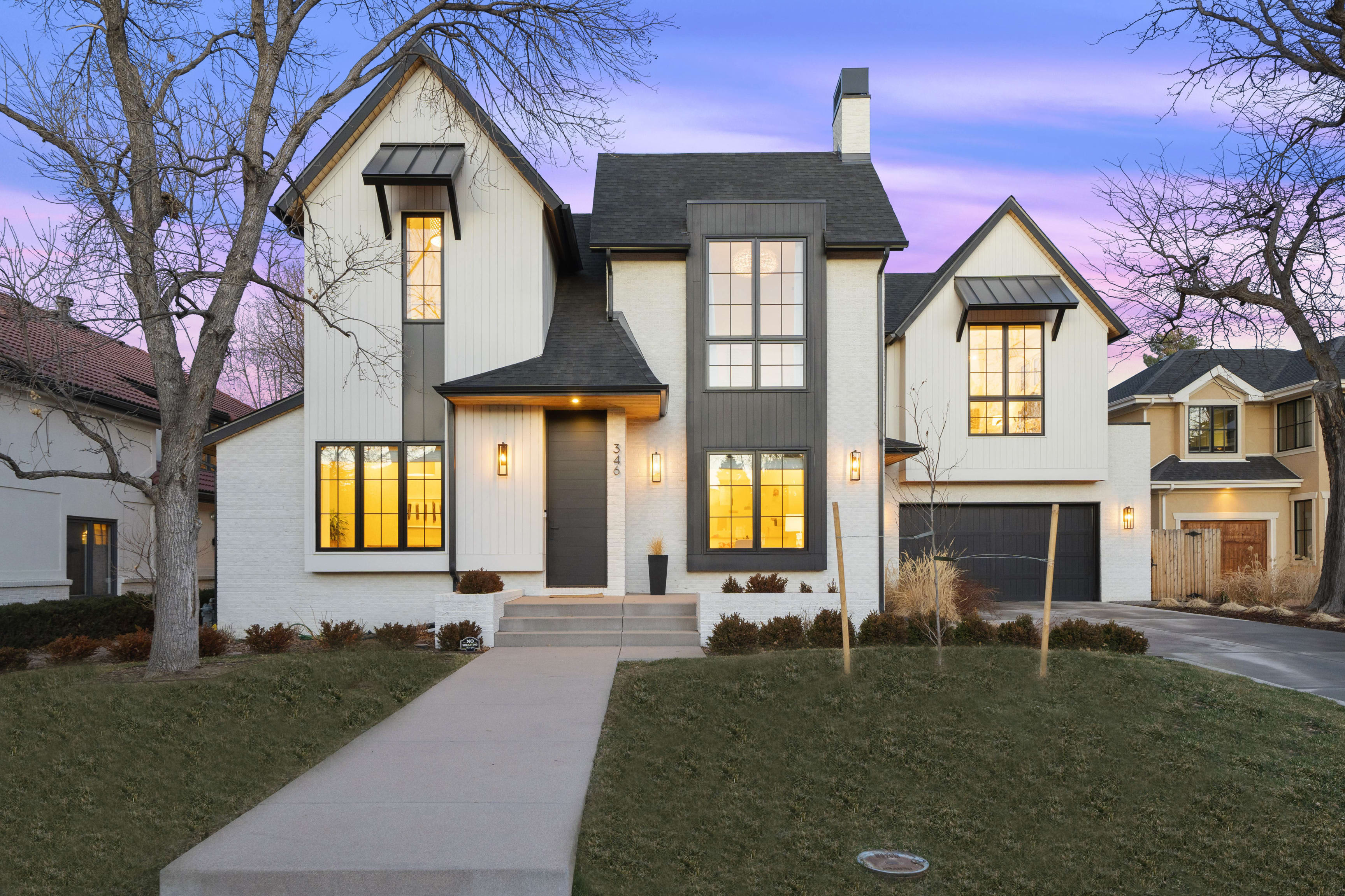  Dusk falls on a modern luxury home with striking architecture, warm interior lights, and a welcoming ambiance.