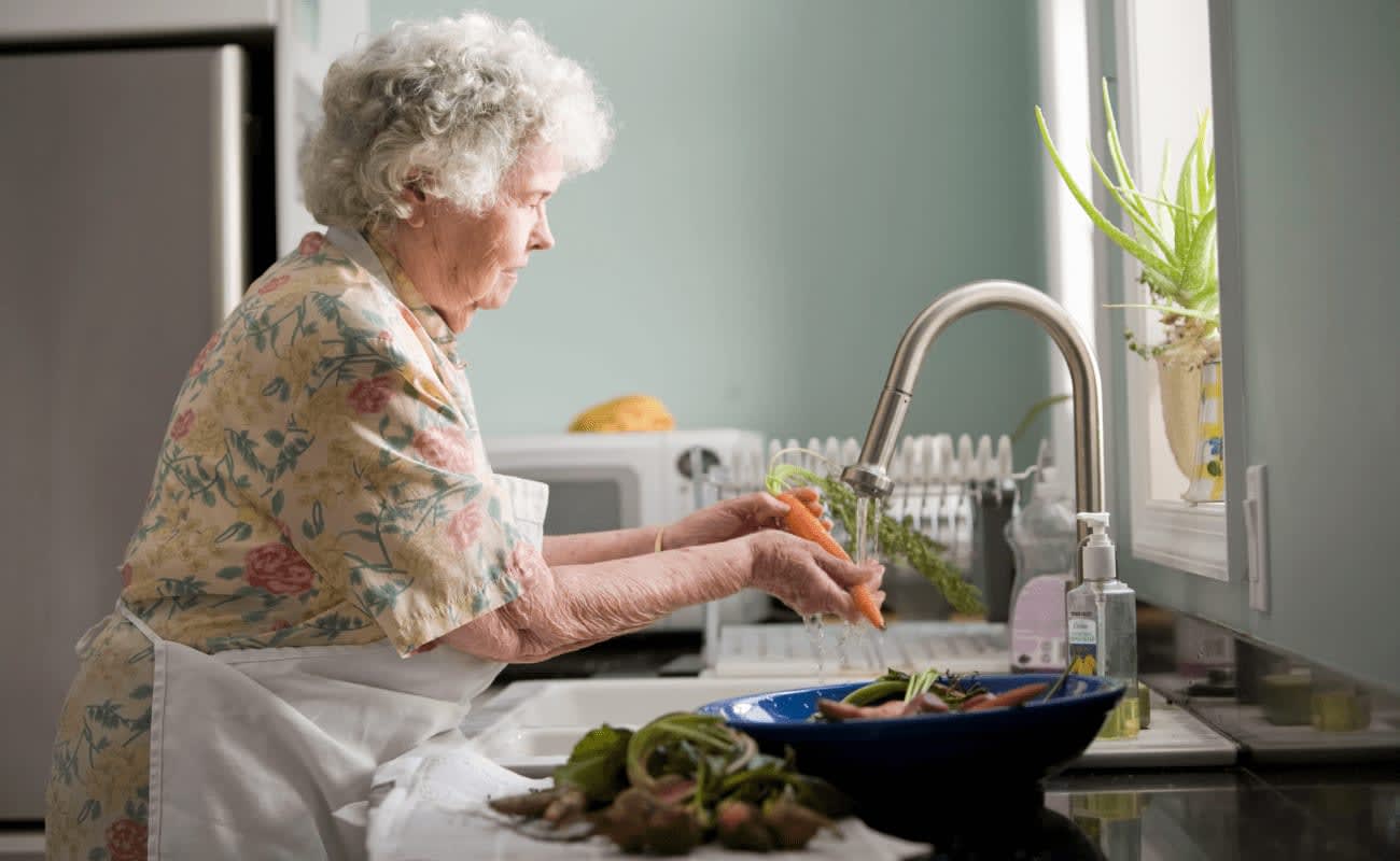 old lady washing vegetables