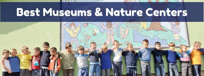 Best Museums & Nature Centers banner with children standing in front of an illustrated wall.