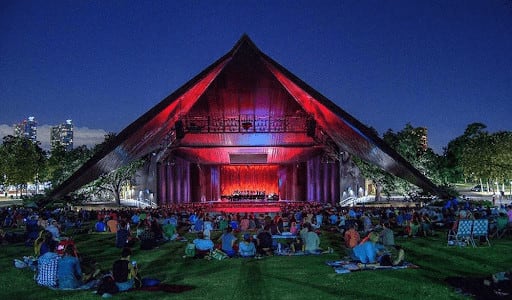 People watching a concert on Miller theaters outdoor stage.