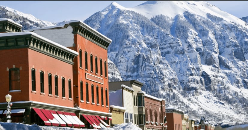 Snow-covered ski slopes with chairlift in Telluride, Colorado, on a clear day.