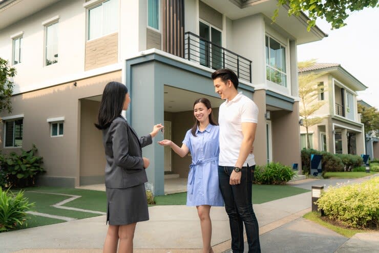  Asian happy smile young couple take keys new big house 