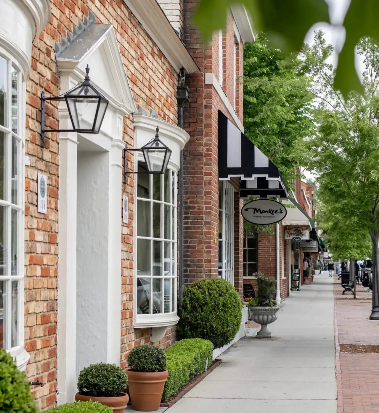 Elegant shopping street with classic brick facades, projecting the sophisticated lifestyle of nearby luxury residences.