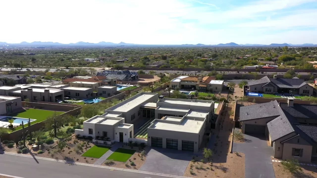 Aerial view of a desert neighborhood showcasing luxury homes, houses, and condos.