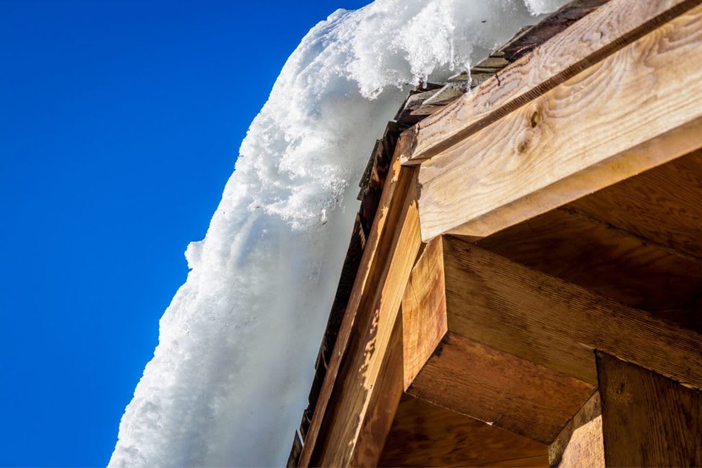 snow on the peak of a roof can leak into a home and cause water damage