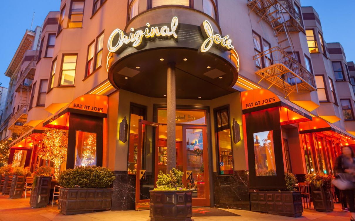 The inviting facade of&nbsp;Original Joe&rsquo;s, an iconic restaurant located in the heart of San Francisco. The warm lighting and outdoor seating create a welcoming ambiance, perfect for a night out in the city.&nbsp;
