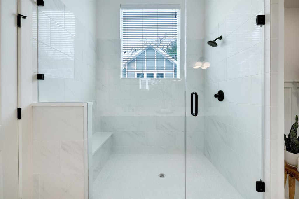 large bathroom shower with glass doors 