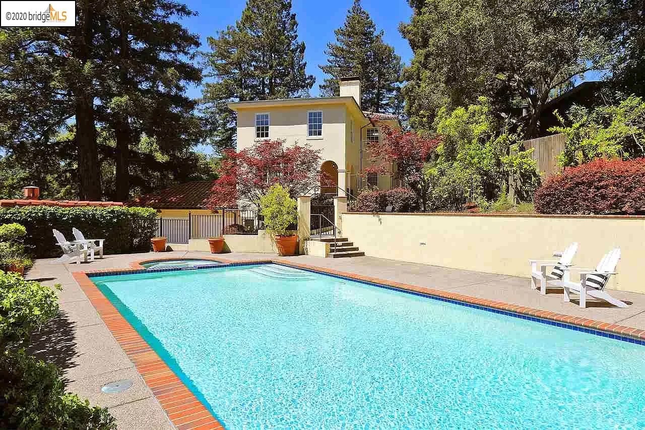 Yellow painted two storey property with long swimming pool