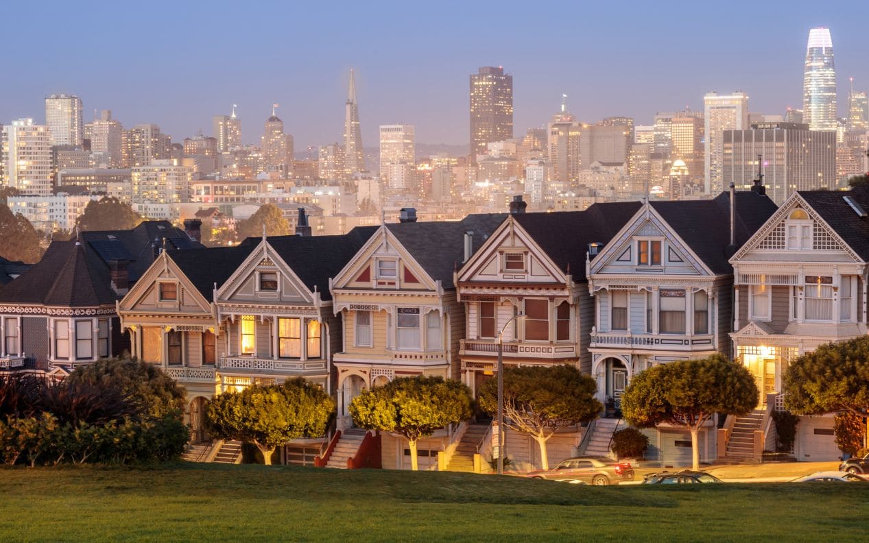 Iconic Victorian Houses and San Francisco Skyline in Alamo Square