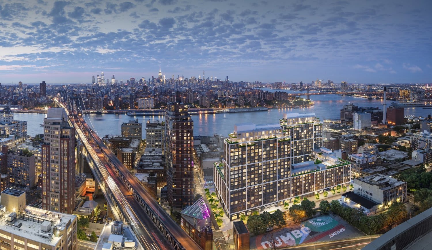 Front & York residential complex overlooking the East River and Manhattan skyline at dusk.