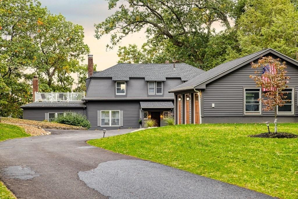 White brick home with black shutters, exuding a charming and inviting atmosphere. Ideal for families for a peaceful retreat.