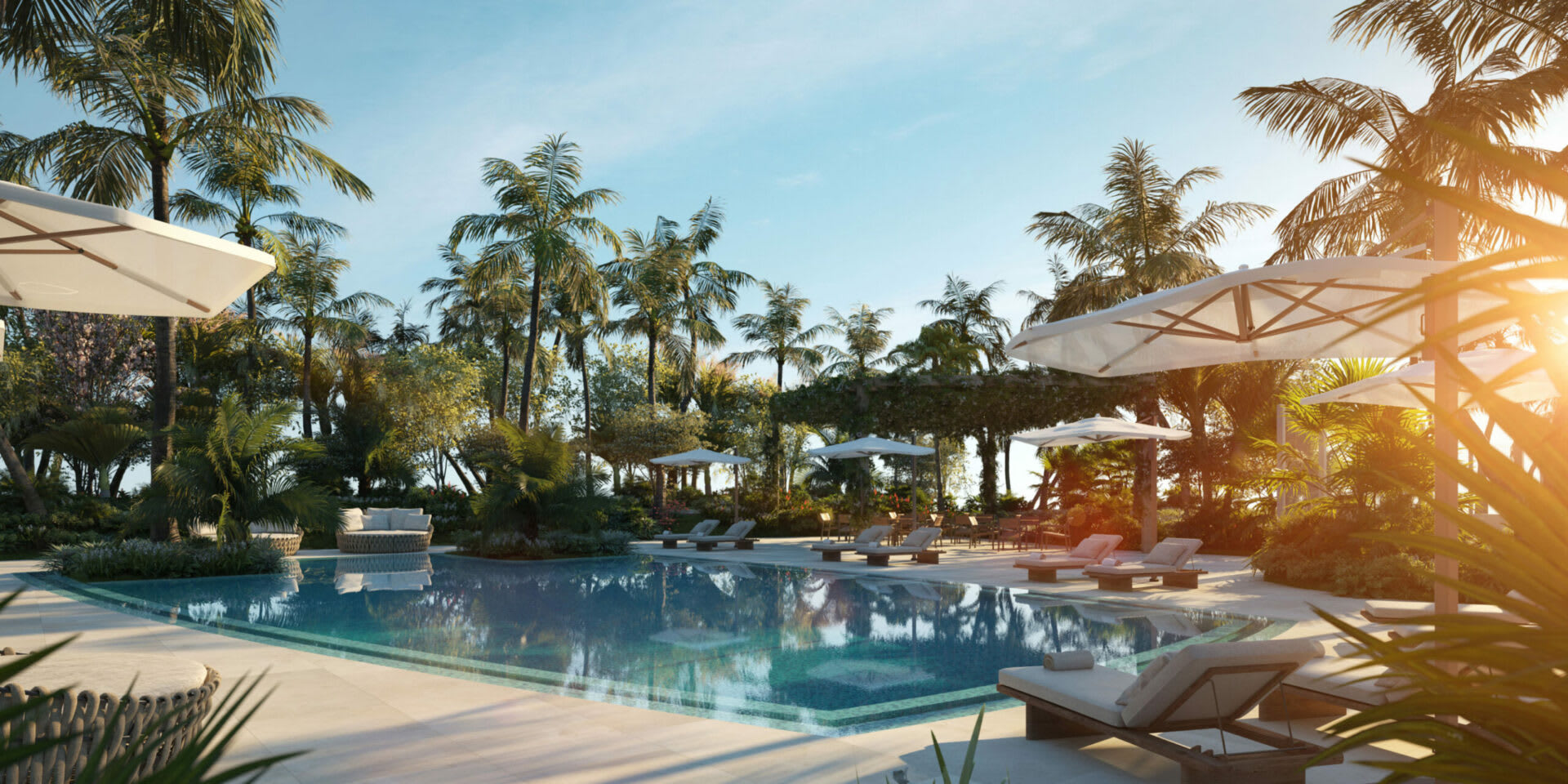 Outdoor pool with palm trees, white umbrellas, and lounge chairs in warm evening light.