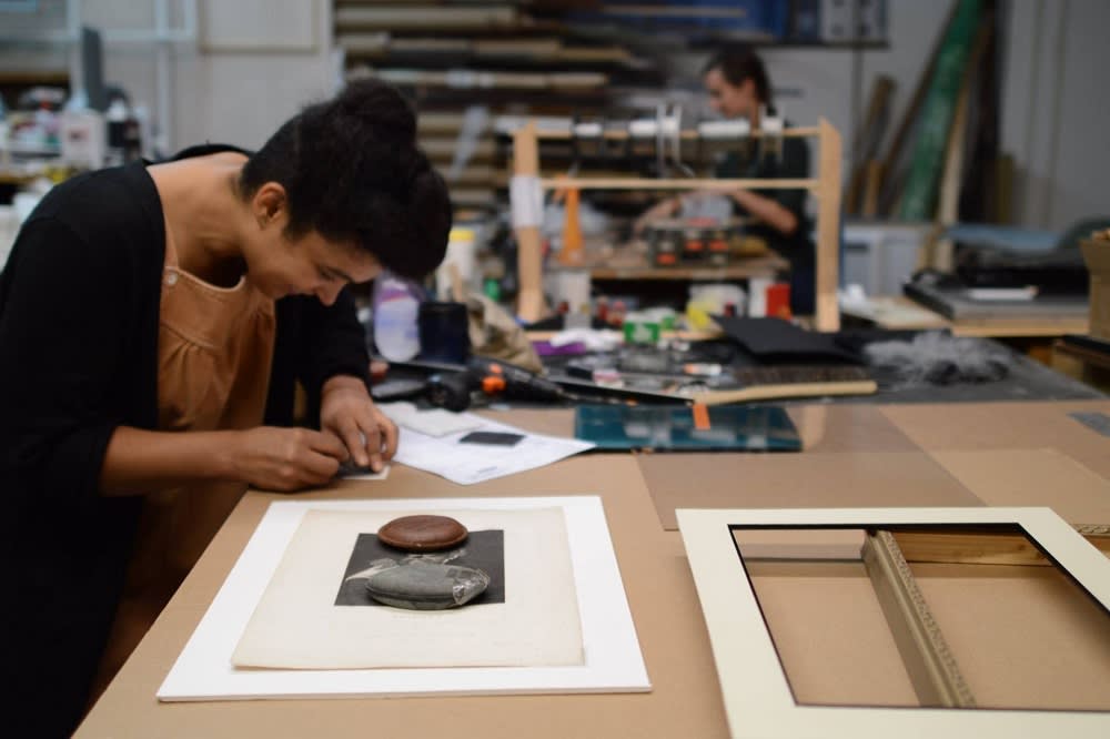 woman working on a frame at FrameWorks Studio of Philadelphia