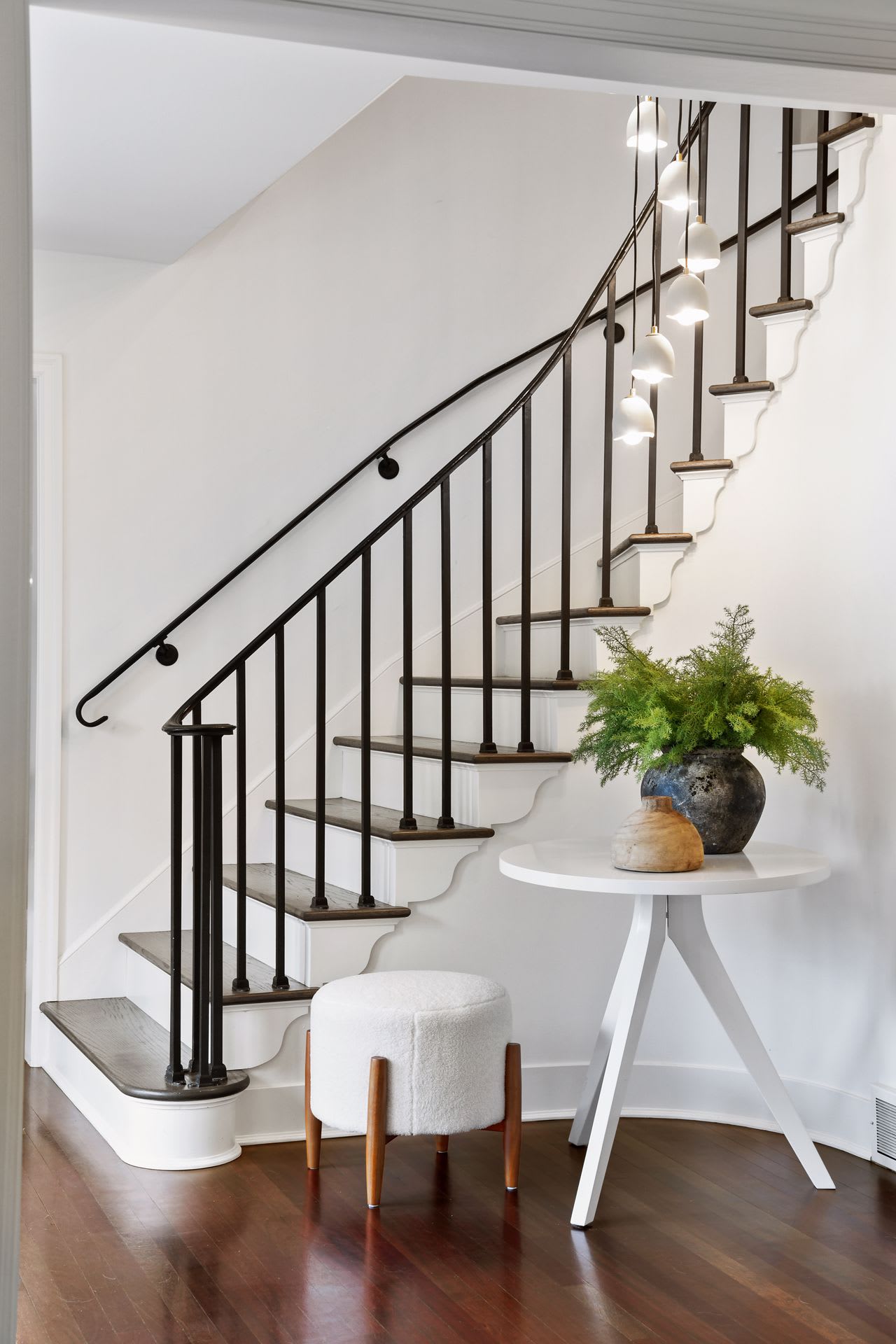 A white staircase with a black metal railing.