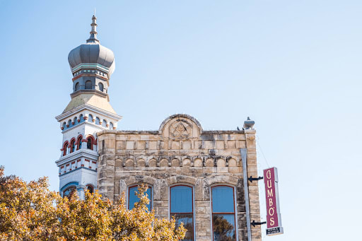 Historic Georgetown building with a blue-and-white turret and a vertical GUMBO'S sign.