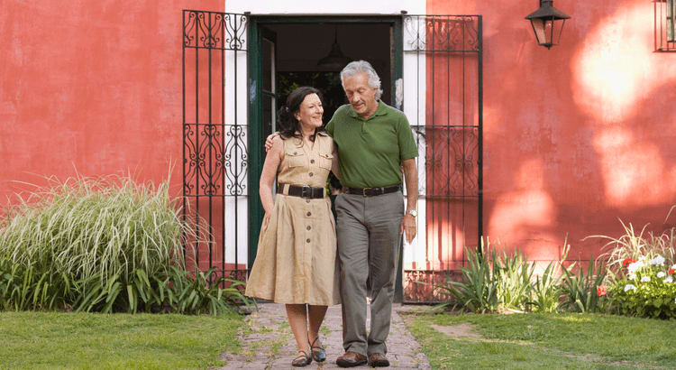 A couple walking outside of their house