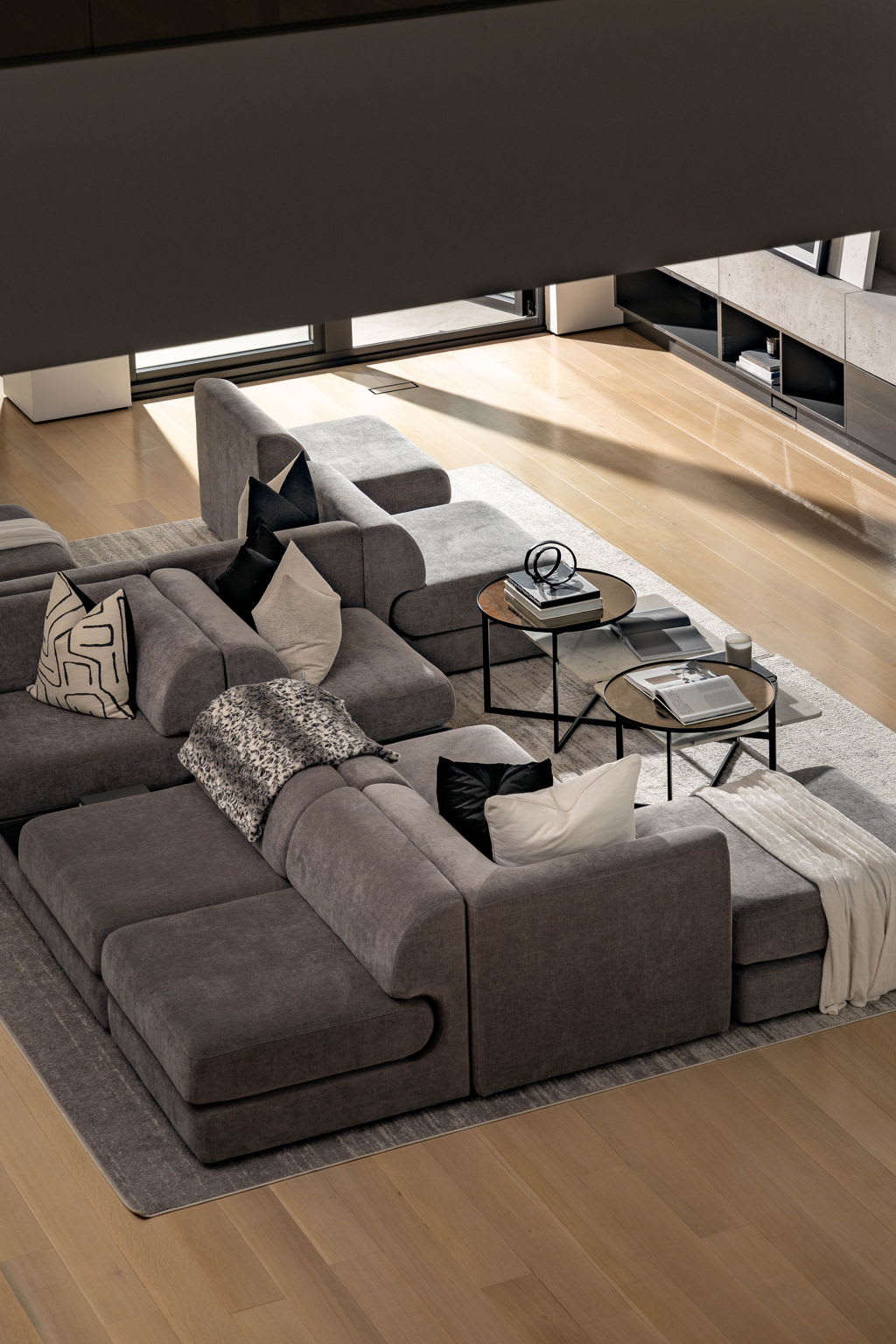 A spacious living room with a large, comfy sectional couch that takes center stage