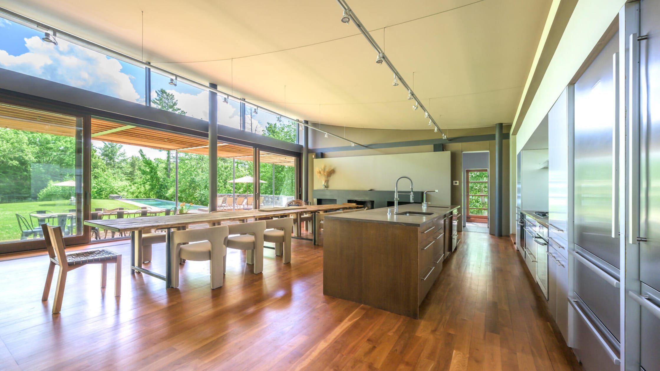 kitchen with a large island and a large kitchen table with large open sliding doors - stone house properties - 250 Long Pond Road