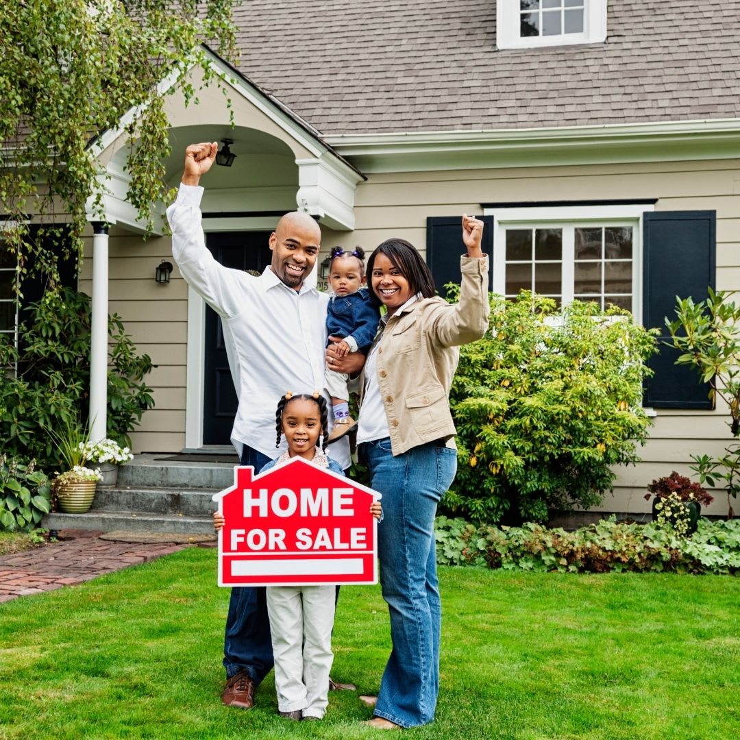 a family waving and holding a for sale sign