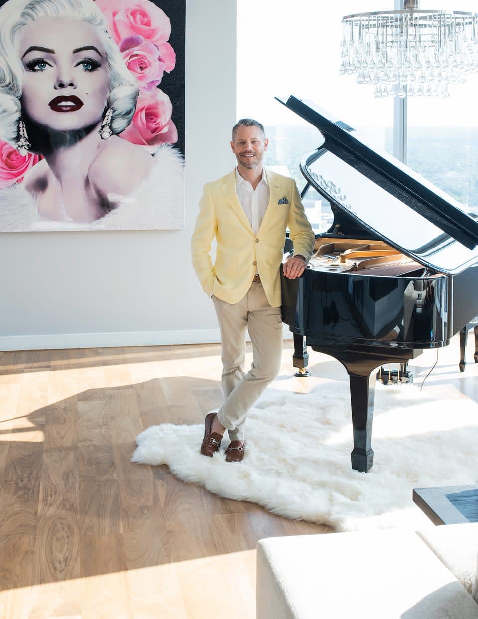 Eric Copper standing beside the grand piano, smiling and ready to play.