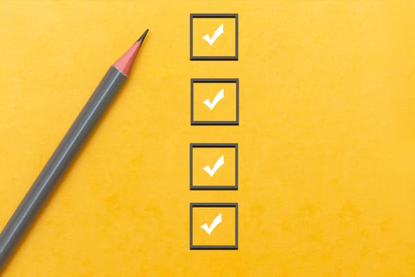 A checklist with boxes checked off and a gray pencil