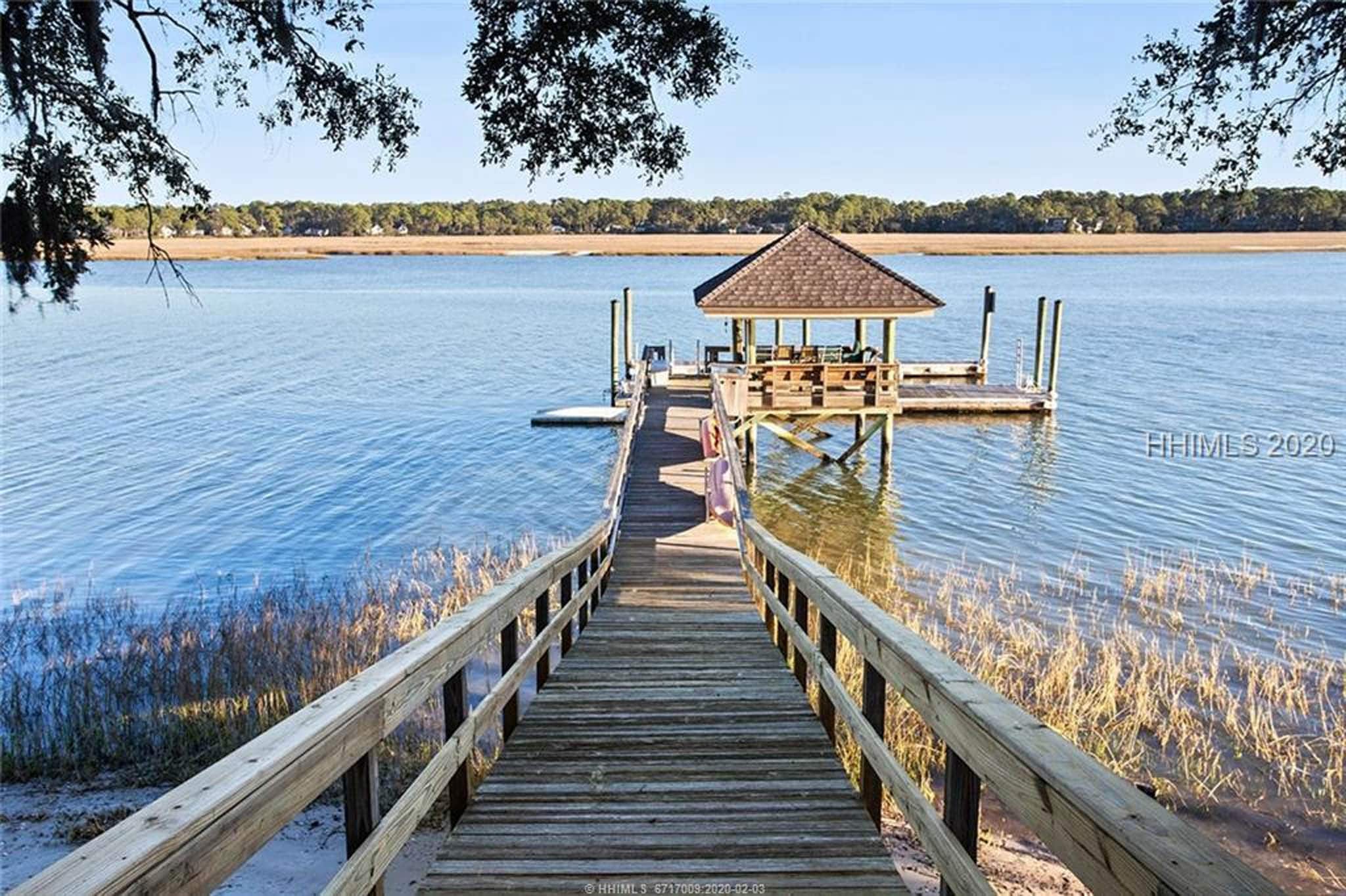 wooden bridge leading out to dock in the marsh