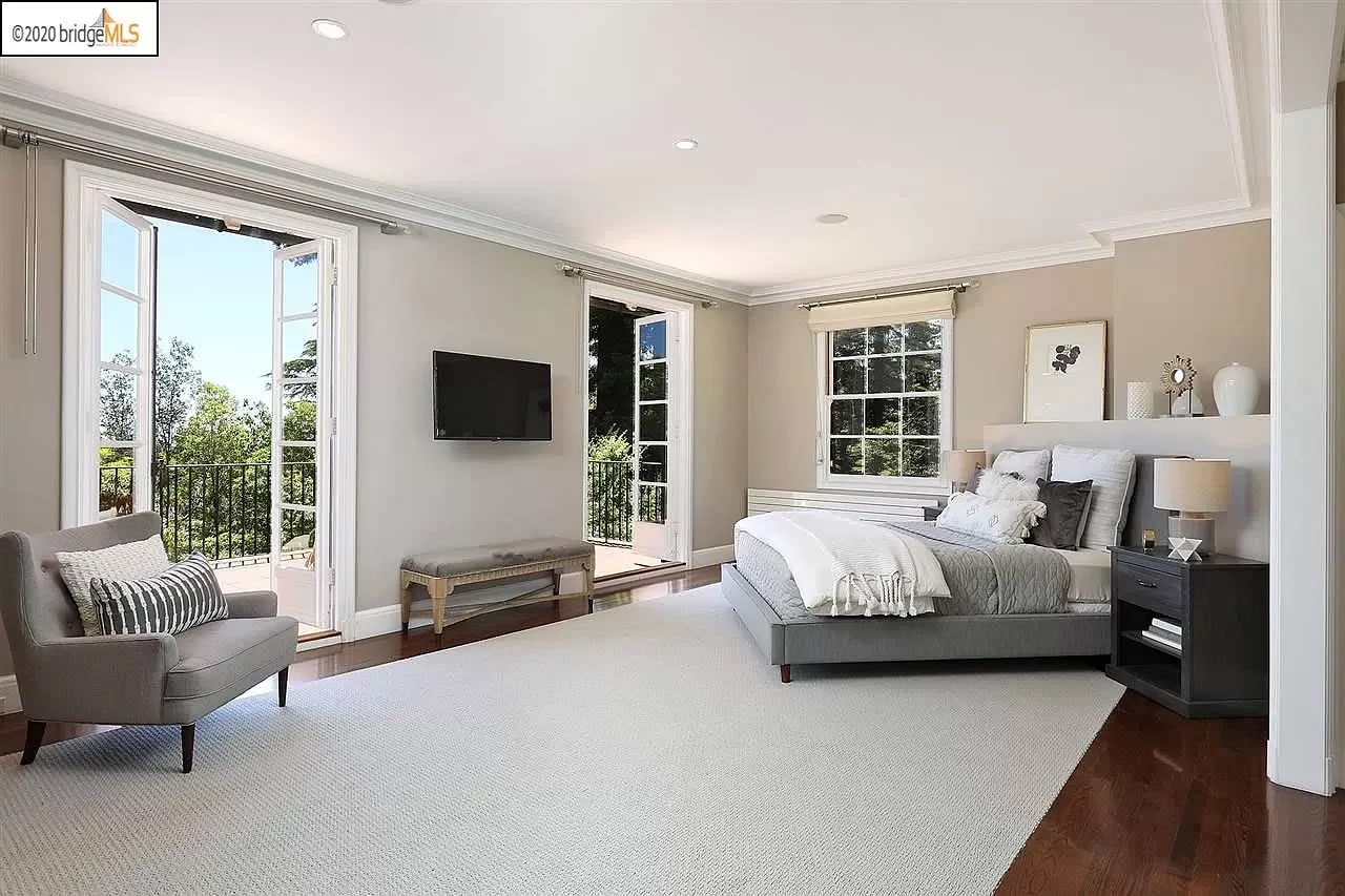 cozy simple bedroom with two doors leading to terrace and minimalist furniture and light grey aesthetic