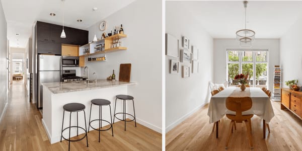 Condo kitchen and dining room with a marble-topped island, wood floors, and large garden-facing windows.