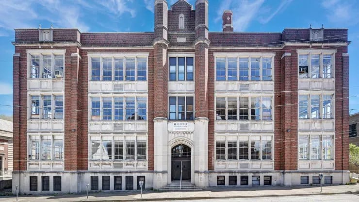 We spent $100,000 on an abandoned high school, and $3.3 million to convert it into apartments—take a look inside