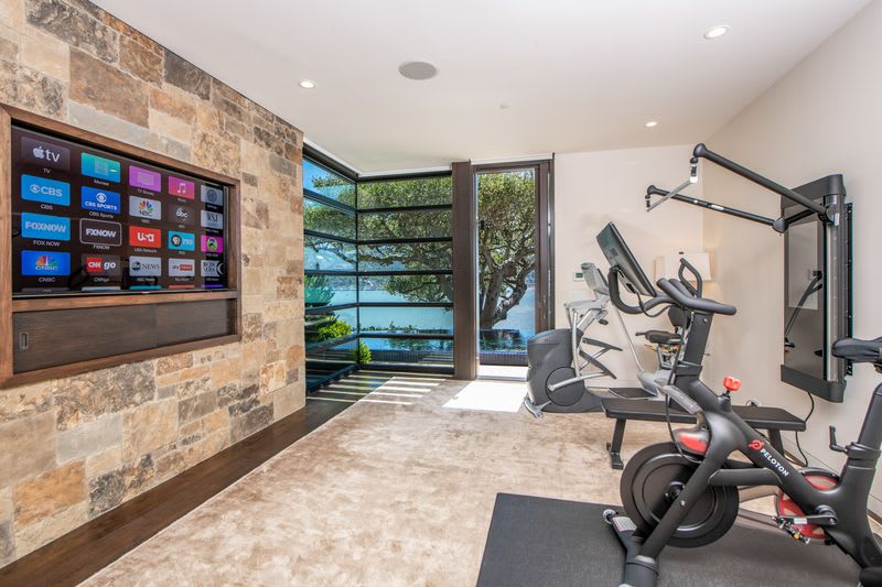 The home gym overlooks the pool.