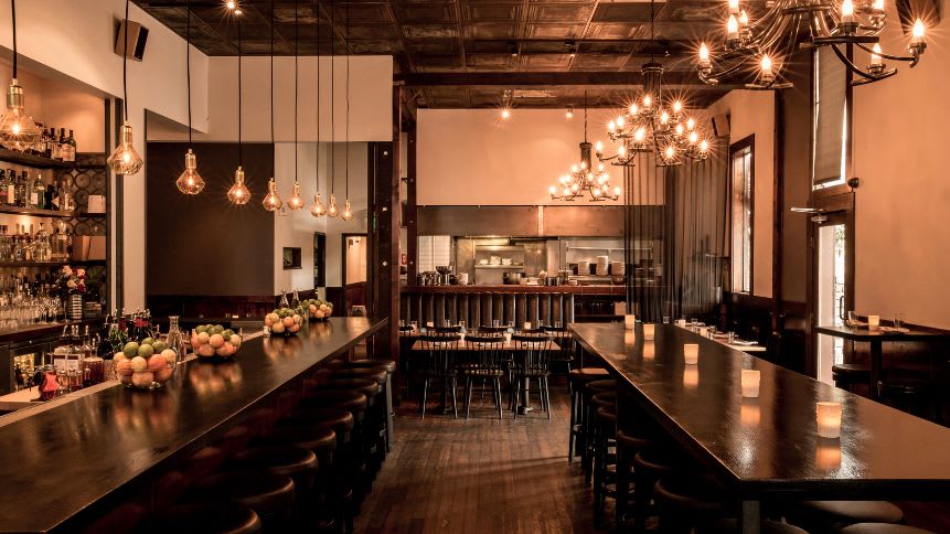 Roma Antica beckons guests with its rich wooden interiors, ambient lighting, and a well-stocked bar adorned with fresh fruits. The elegant chandeliers cast a soft glow, highlighting the meticulous craftsmanship and timeless design that defines this beloved dining haven.