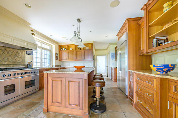 A chef's kitchen with custom cherry cabinets and granite countertops