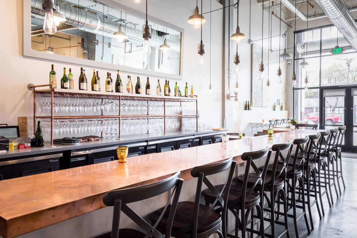 a long bar with stools in front of it