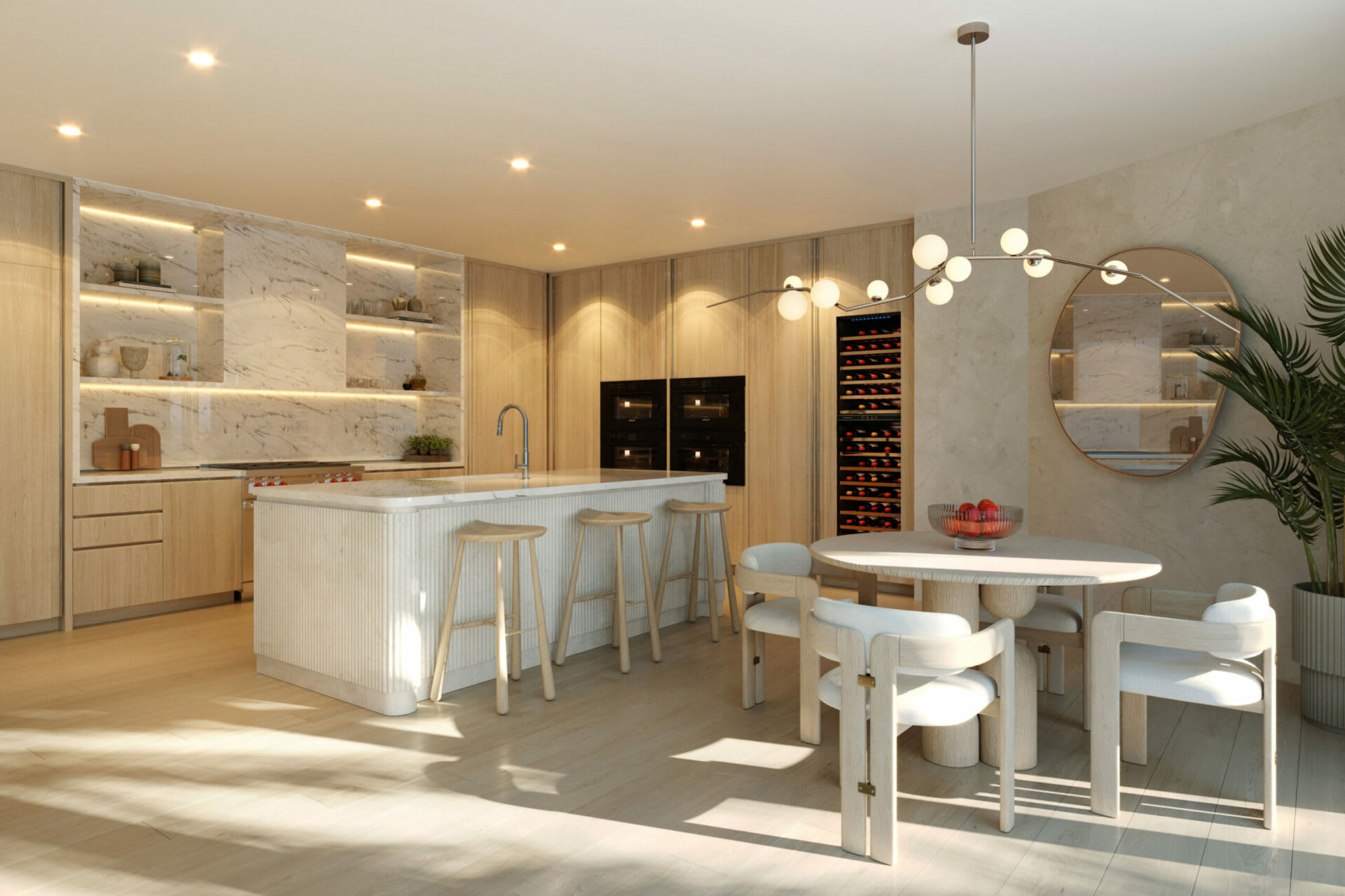 Modern kitchen and dining area with a marble island, light wood cabinetry, and sculptural pendant light.