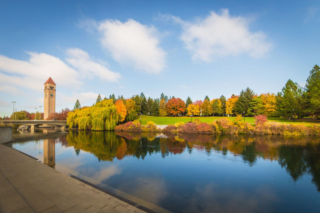 Riverfront Park clocktower in Spokane with colorful fall foliage. 