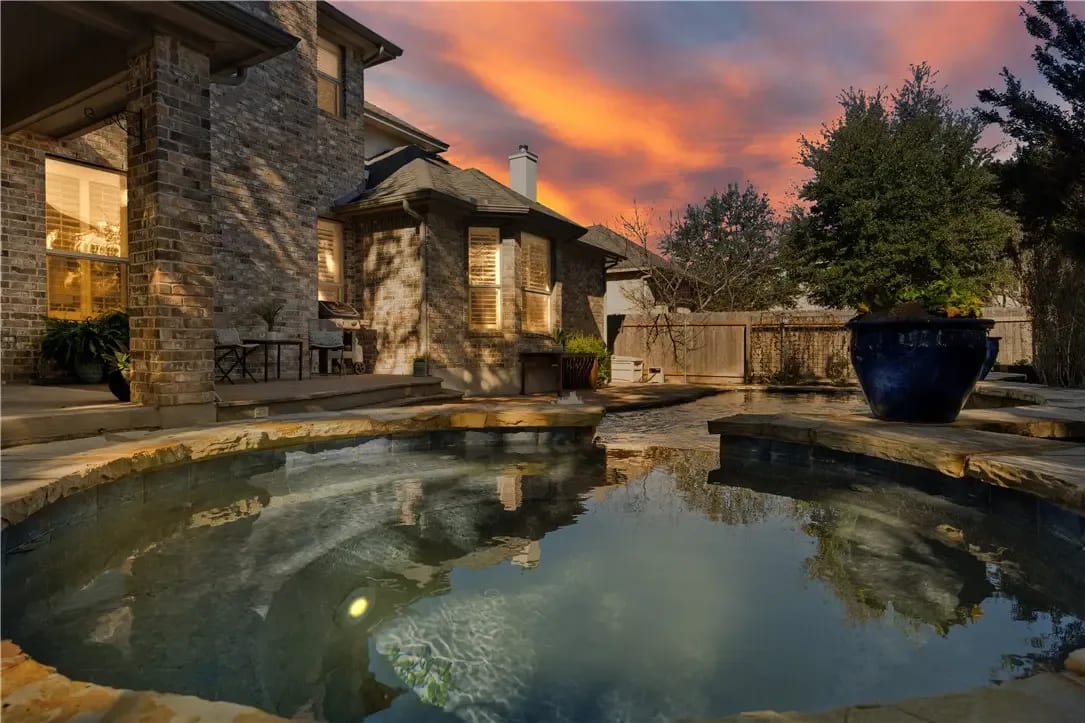 A house with a large pool in the backyard.