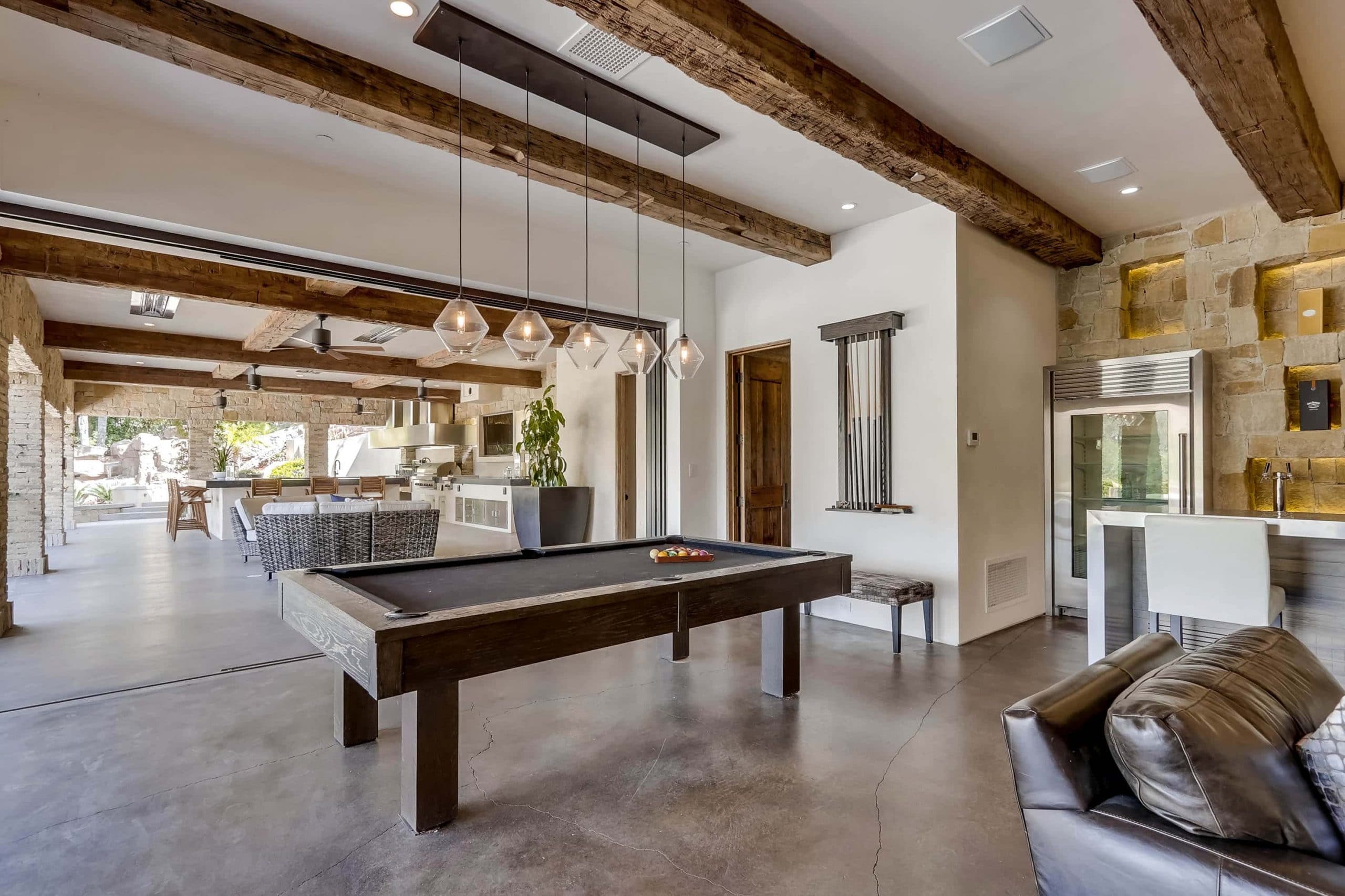 Wood beamed ceilings, retractable walls of glass, pool table, custom lighting, and living room at 22355 Starwood Dr, Yorba Linda