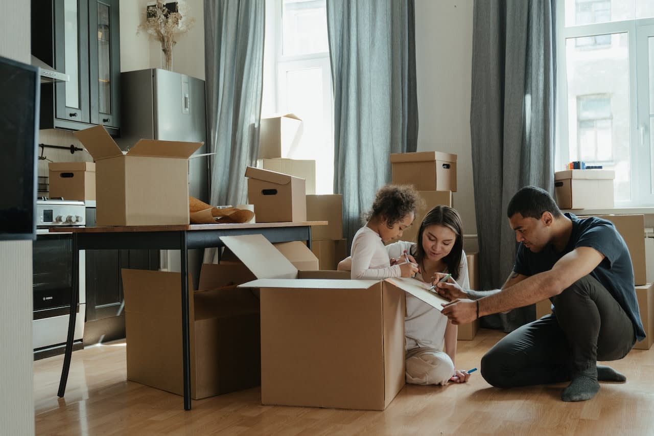 Family packing boxes to move, buy a home or sell in the San Francisco Bay Area