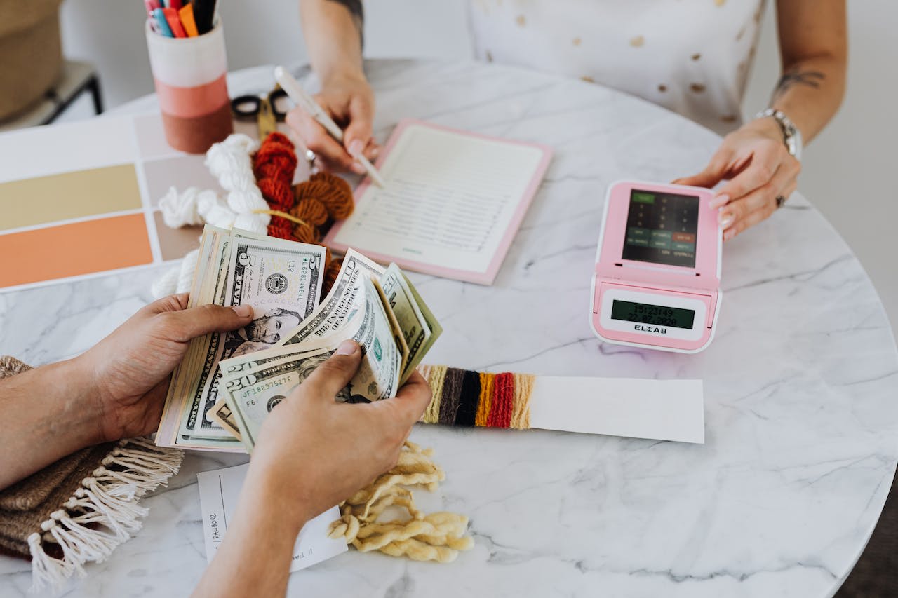 Man and woman holding and calculating money.