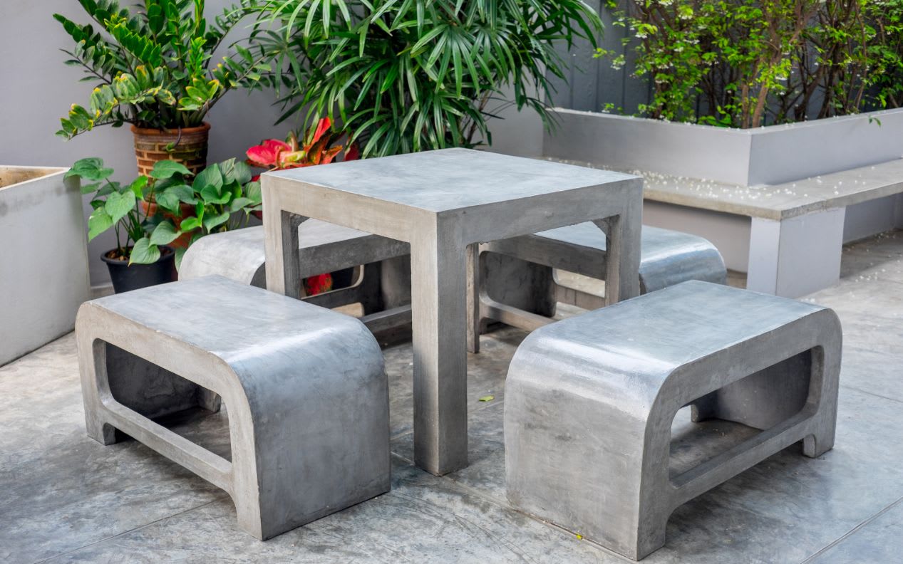 Concrete outdoor furniture set in small garden
