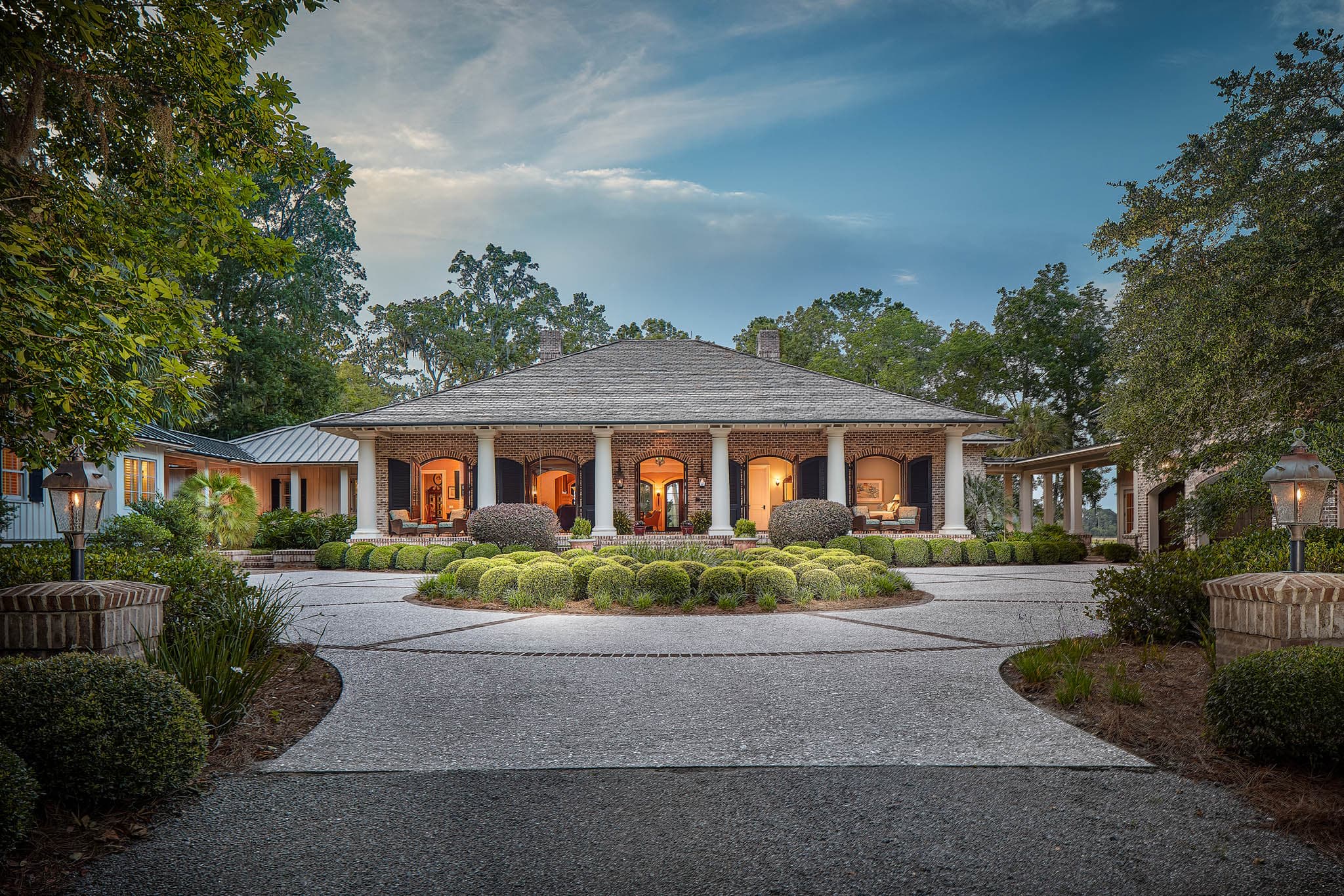 Front view of home with lights on during twilight